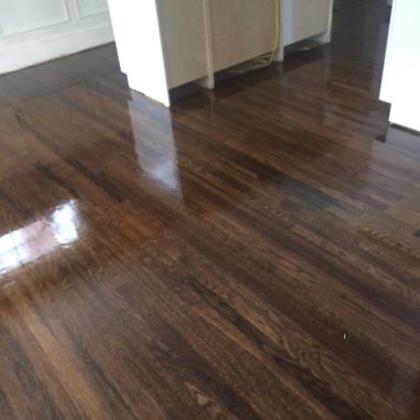 glossy brown hardwood flooring for a kitchen with an island