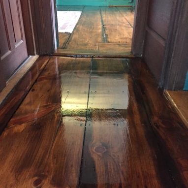 glossy brown hardwood flooring for a room with brown entryway