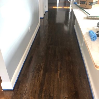 hallway with dark brown flooring
